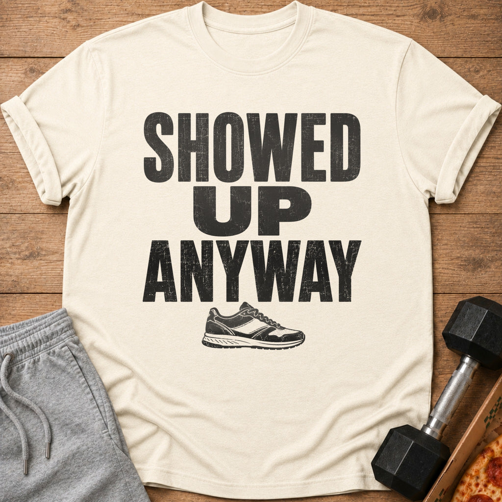 Cream t-shirt with "SHOWED UP ANYWAY" text and a sneaker graphic.
