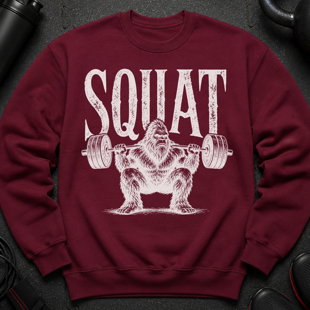 Maroon sweatshirt with distressed white "SQUAT" text and Bigfoot lifting weights graphic.