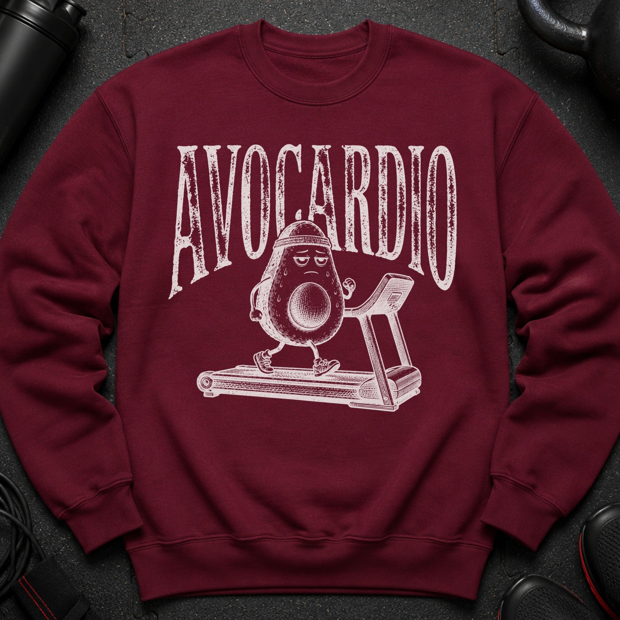 Maroon sweatshirt with "AVOCARDIO" text and an avocado character running on a treadmill.