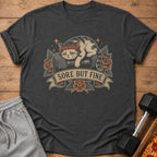 T-shirt with a tired cat on a dumbbell and the text "Sore But Fine".