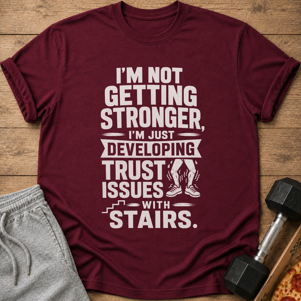 Maroon t-shirt with white text and graphic about developing trust issues with stairs.