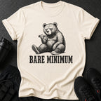 Cream t-shirt with a drawing of a bear lifting a dumbbell and the text "BARE MINIMUM".
