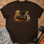 Three puppies rest paws on a dumbbell surrounded by autumn leaves and a pumpkin.