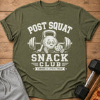 Olive t-shirt with "POST SQUAT SNACK CLUB EARNED A LITTLE TREAT" text and graphics.
