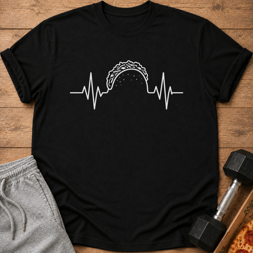 Black t-shirt with white taco heartbeat graphic, placed next to sweatpants and dumbbell.