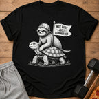 Black t-shirt with a sloth riding a turtle, holding a "Not Fast - Just Committed" flag.