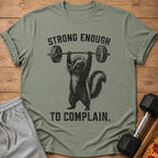Green t-shirt with a skunk lifting a barbell and text that reads "STRONG ENOUGH TO COMPLAIN."