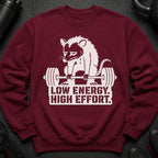 Maroon sweatshirt with white graphics of a tired opossum lifting a barbell and text.