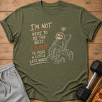 Green t-shirt with "I'm not here to be the best. I'm here to feel a little less worst." text and sloth graphic.