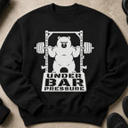 Black sweatshirt with a white graphic of a bear lifting a barbell with text "UNDER BAR PRESSURE".