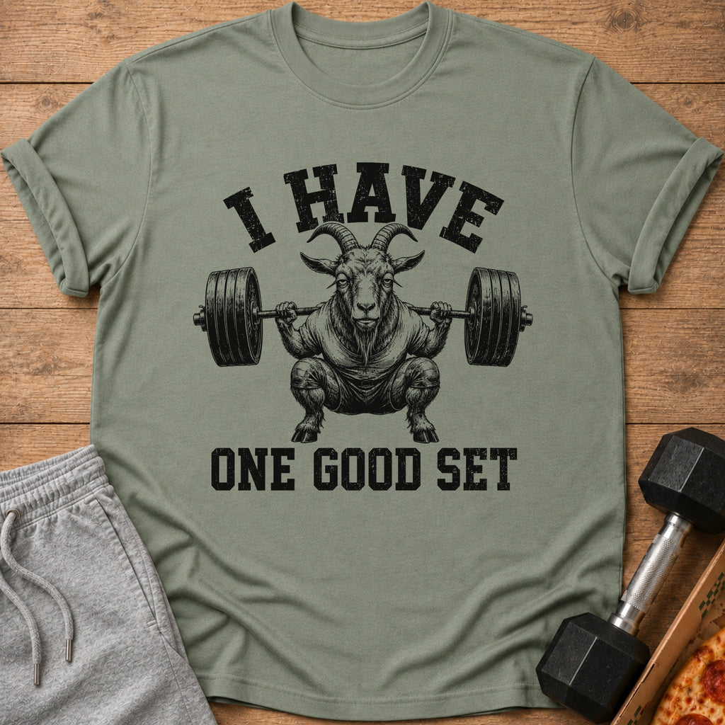 Green t-shirt with graphic of goat lifting barbell, text "I HAVE ONE GOOD SET".