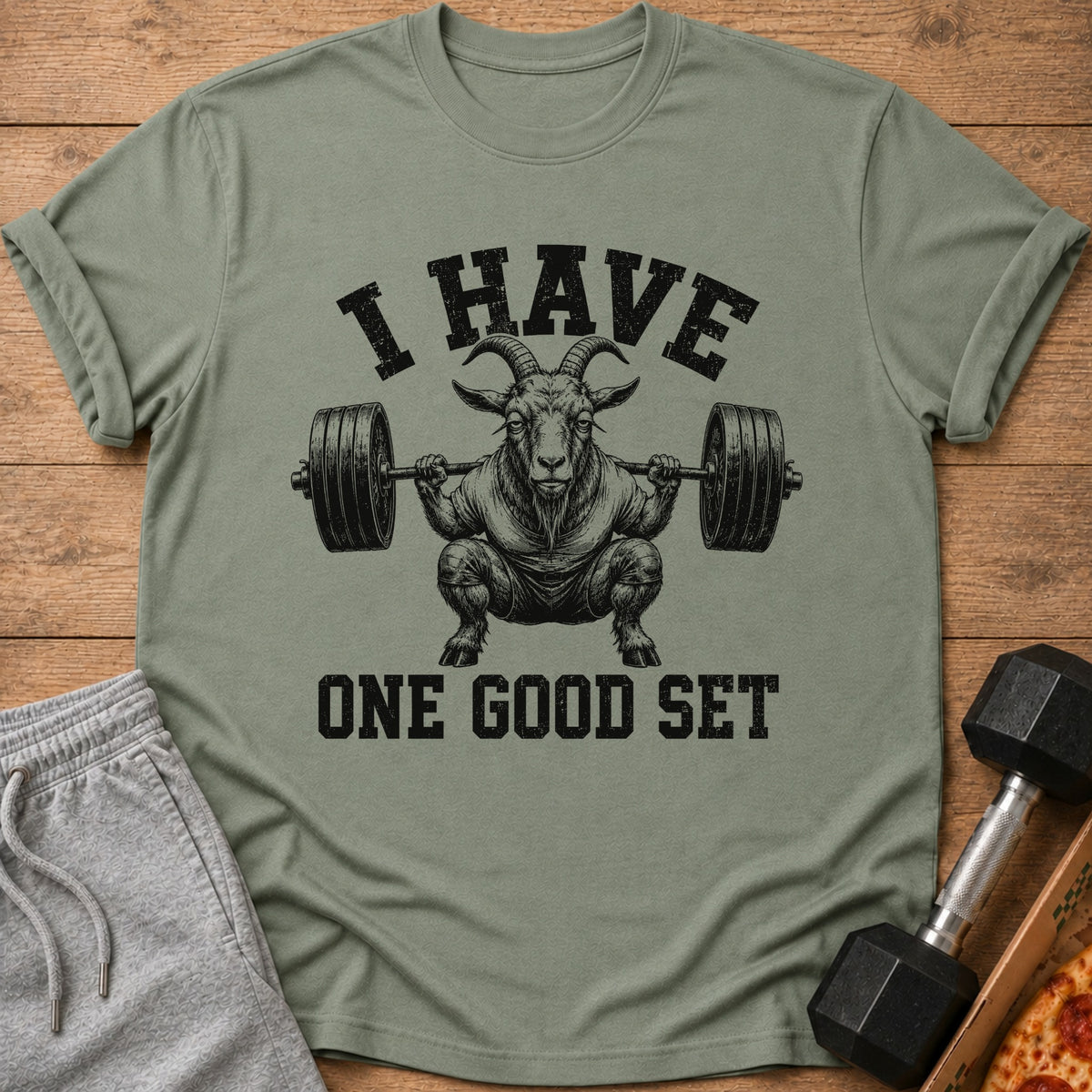 Green t-shirt with graphic of goat lifting barbell, text "I HAVE ONE GOOD SET".