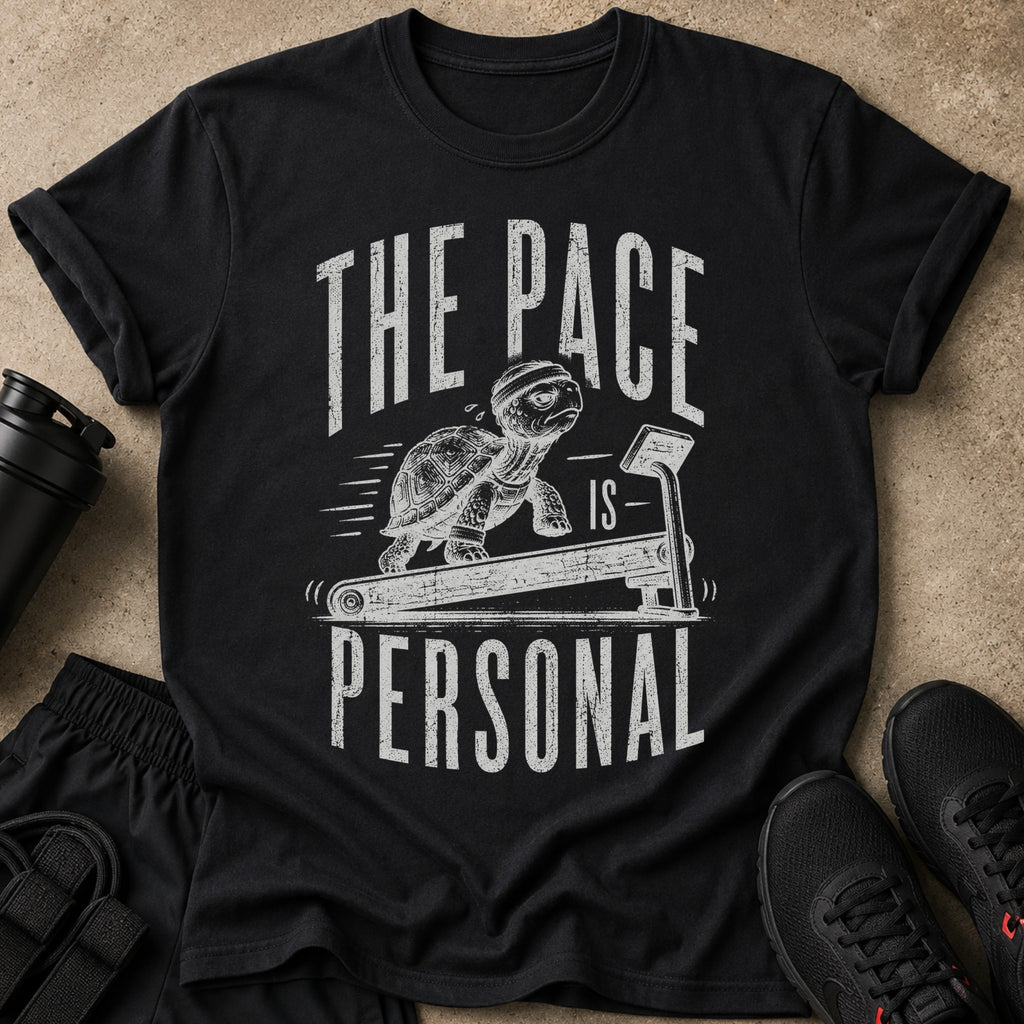 Black t-shirt with a distressed graphic of a turtle running on a treadmill and text.