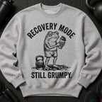 Grey sweatshirt with a drawing of a grumpy frog holding a shaker bottle and the text "RECOVERY MODE STILL GRUMPY."