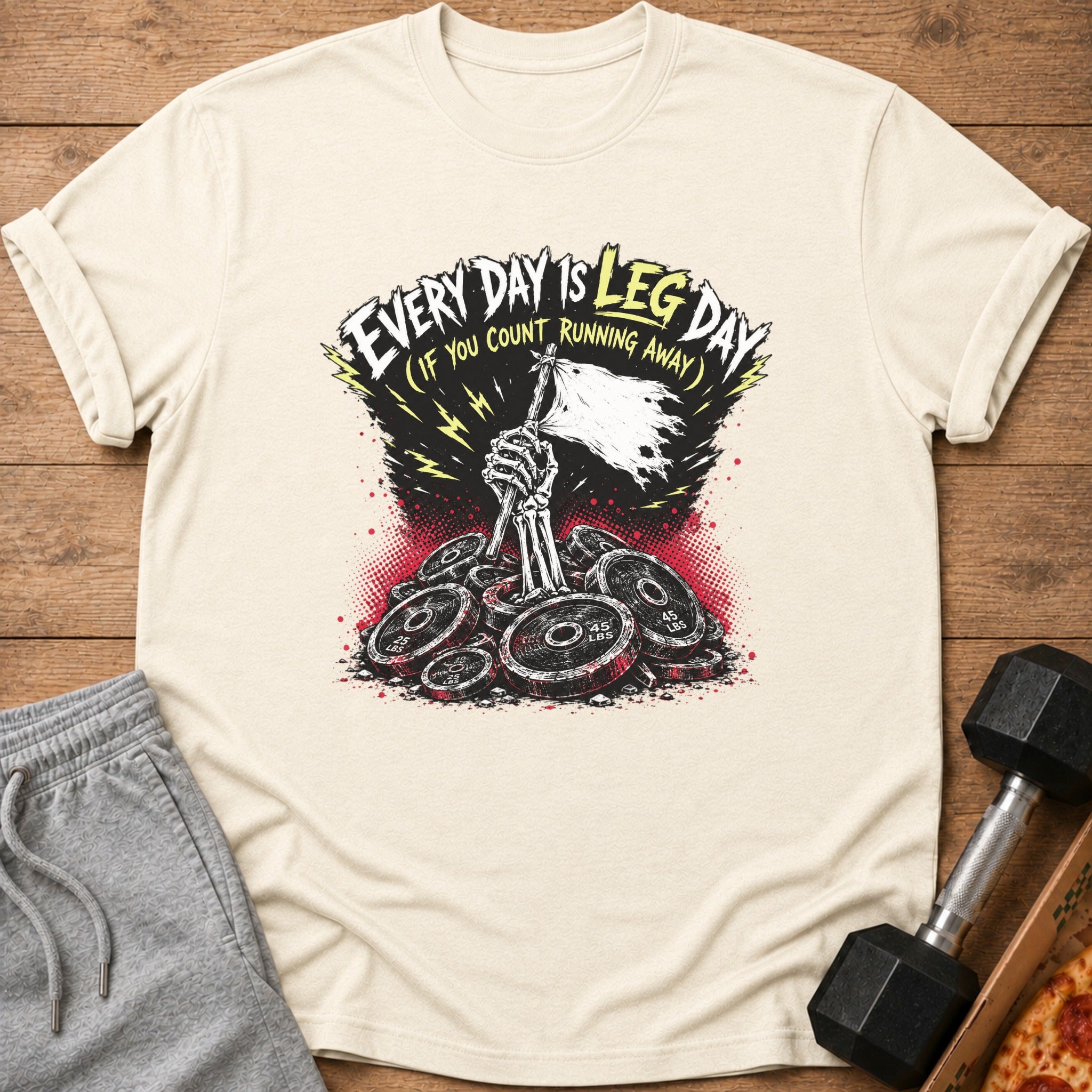 T-shirt with skeleton hand holding flag over weight plates, reads "Every Day Is Leg Day (If You Count Running Away)".