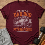 Maroon t-shirt with a bear on a couch holding a shaker, reading "It's Not a Dad Bod, It's a Father Figure."