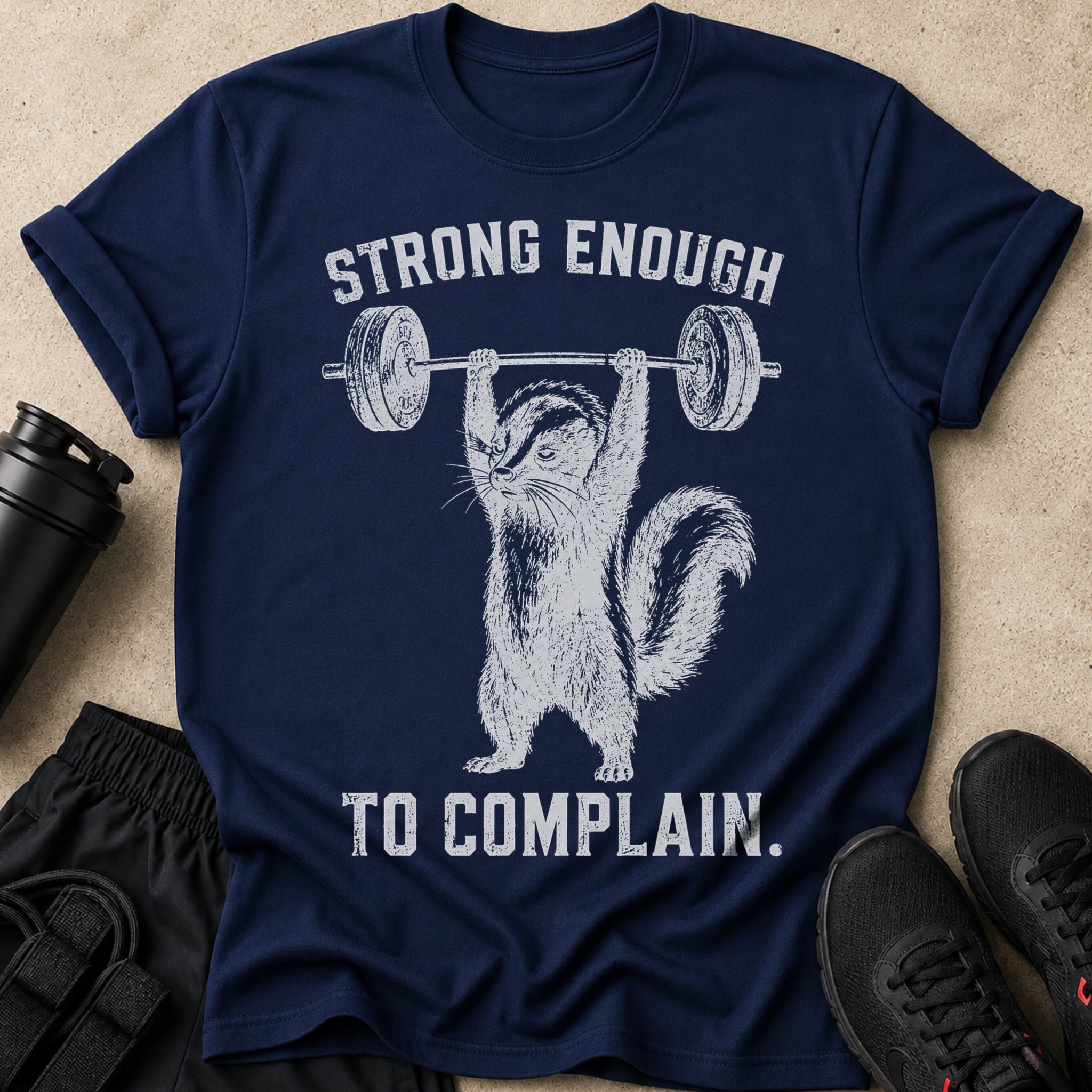 Navy t-shirt with a distressed graphic of a chipmunk lifting a barbell and text "STRONG ENOUGH TO COMPLAIN."