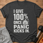 Dark gray t-shirt with white text: "I GIVE 100% ONCE PANIC KICKS IN."