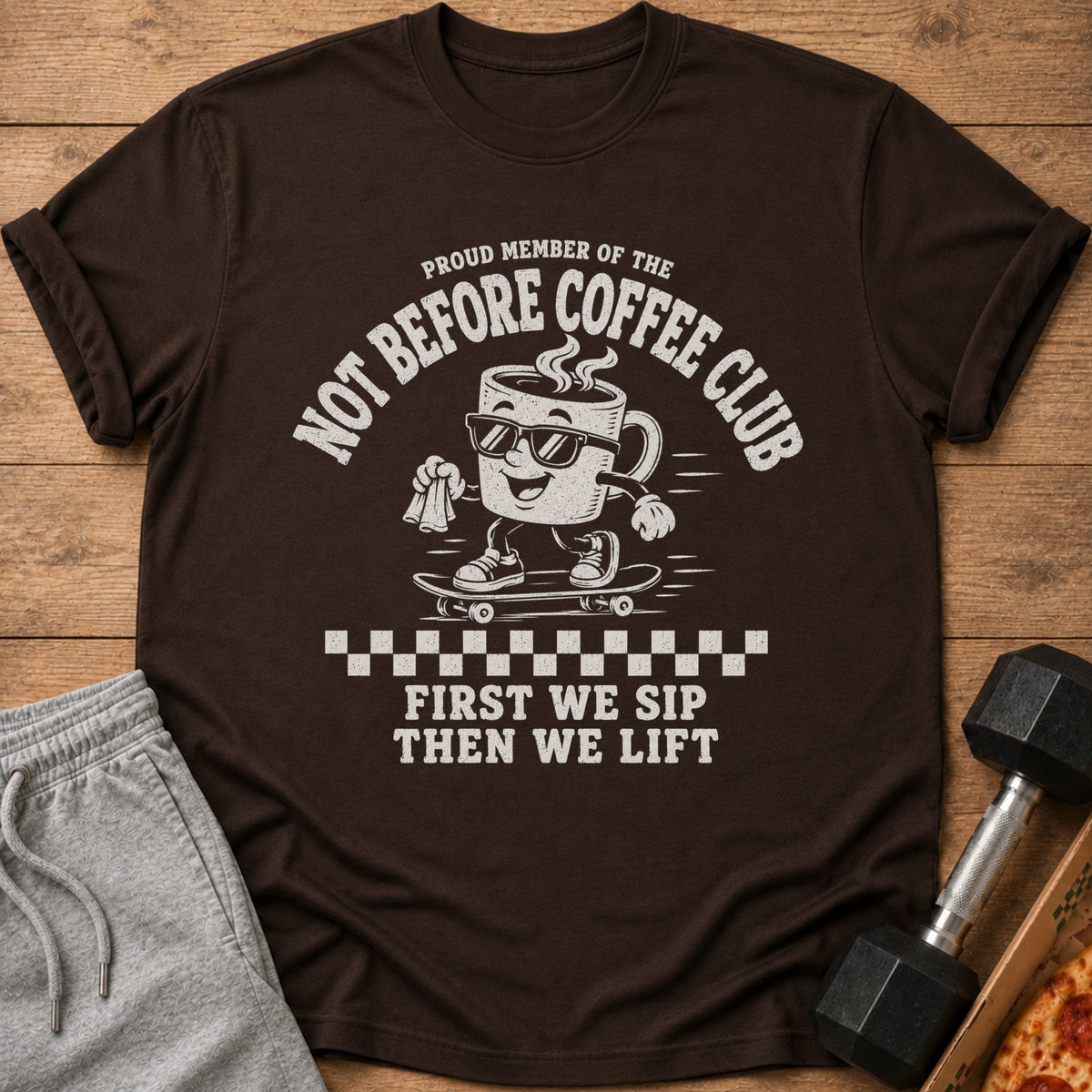 Brown t-shirt with "Proud Member of the Not Before Coffee Club" and cartoon coffee cup.
