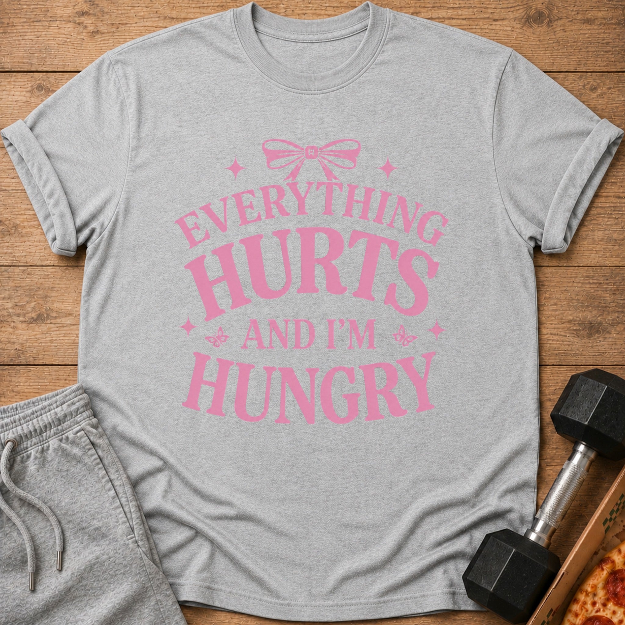 Grey t-shirt with pink text "EVERYTHING HURTS AND I'M HUNGRY"