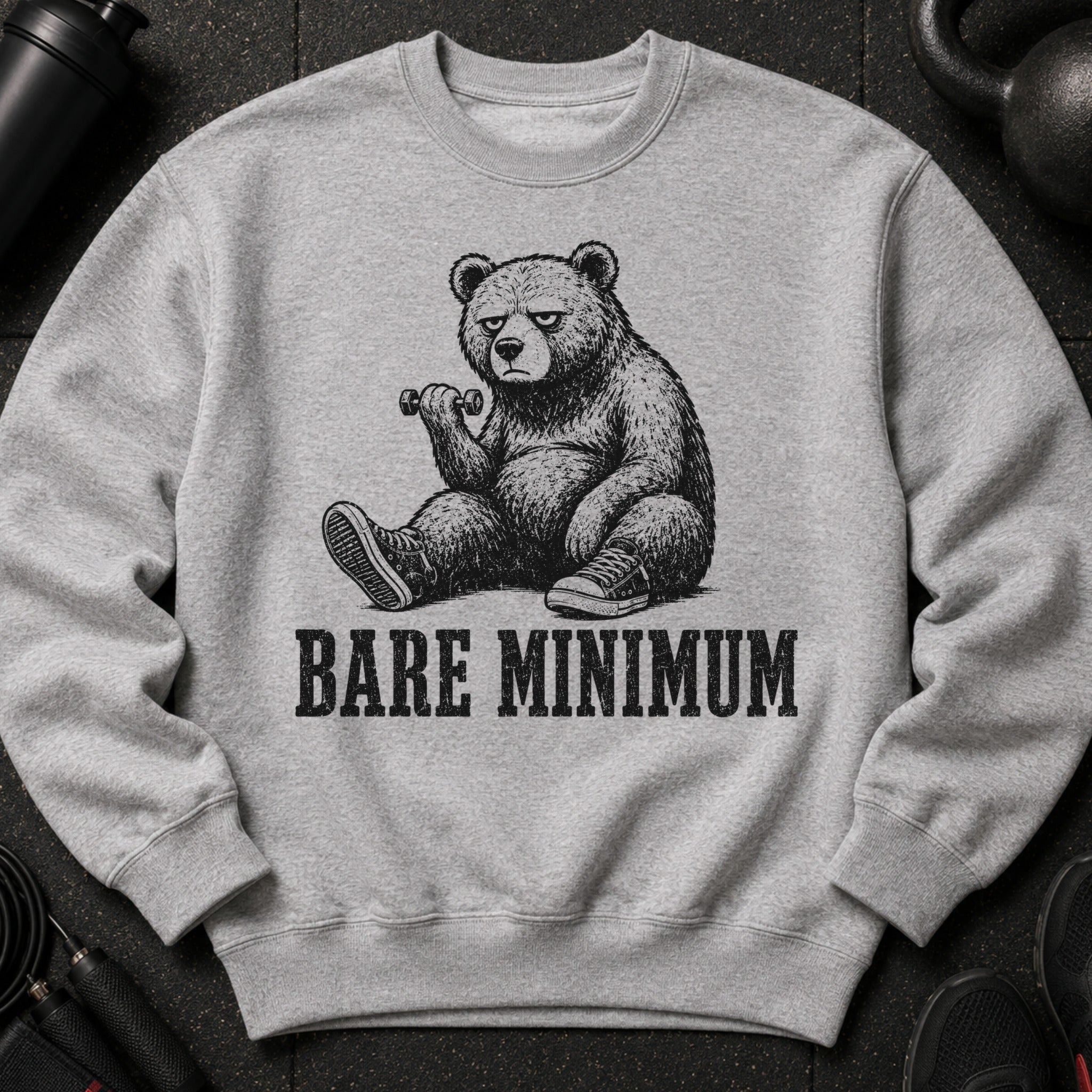 Grey sweatshirt featuring a bear sitting with a dumbbell and the text "BARE MINIMUM".