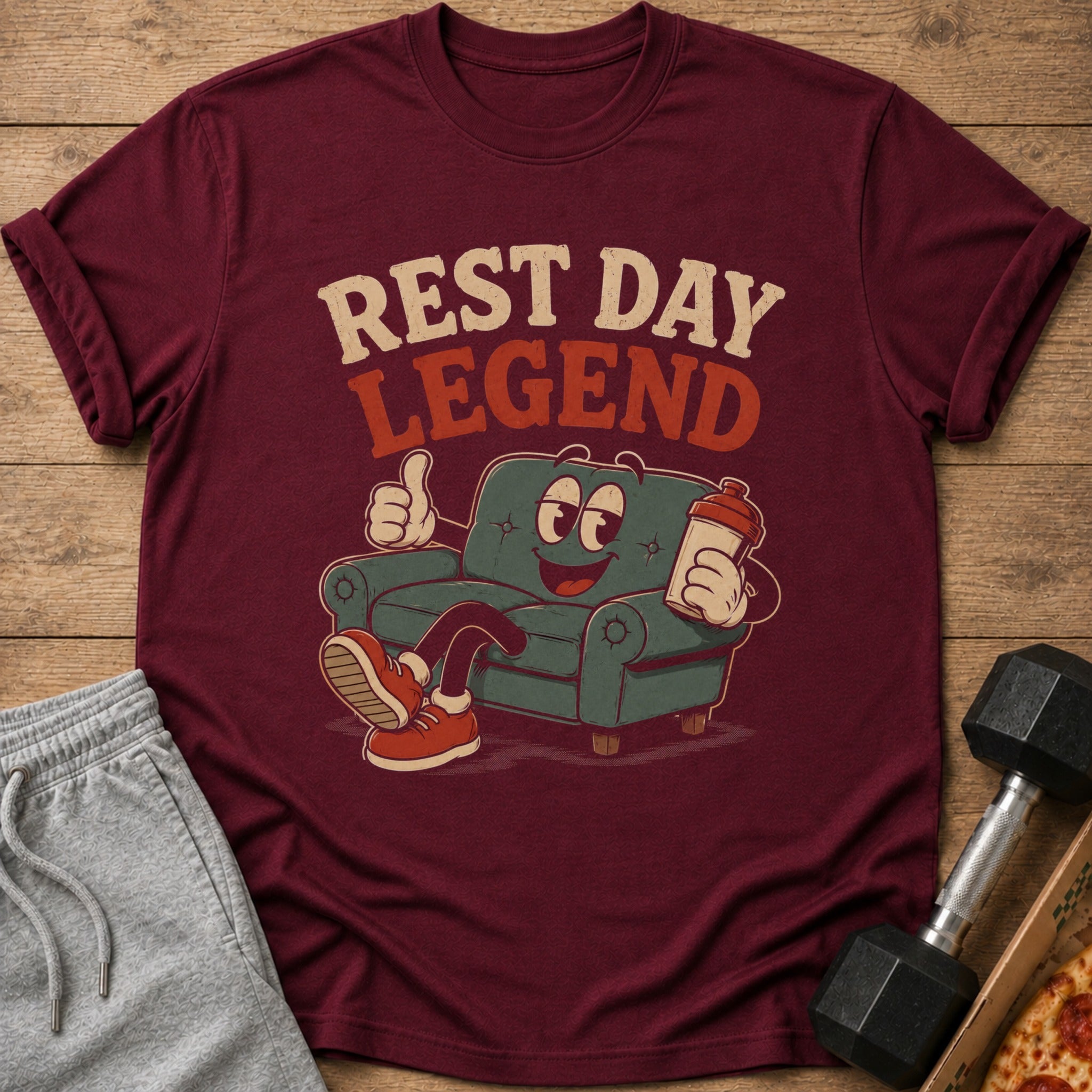 Maroon t-shirt with cartoon couch graphic and text "REST DAY LEGEND".