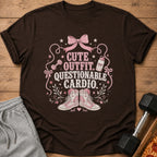 Brown t-shirt with "Cute Outfit. Questionable Cardio." text, pink bow, dumbbell, water bottle, and sneakers.