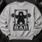 Black graphic of bear on barbell with text "UNDER BAR PRESSURE" on gray sweatshirt.