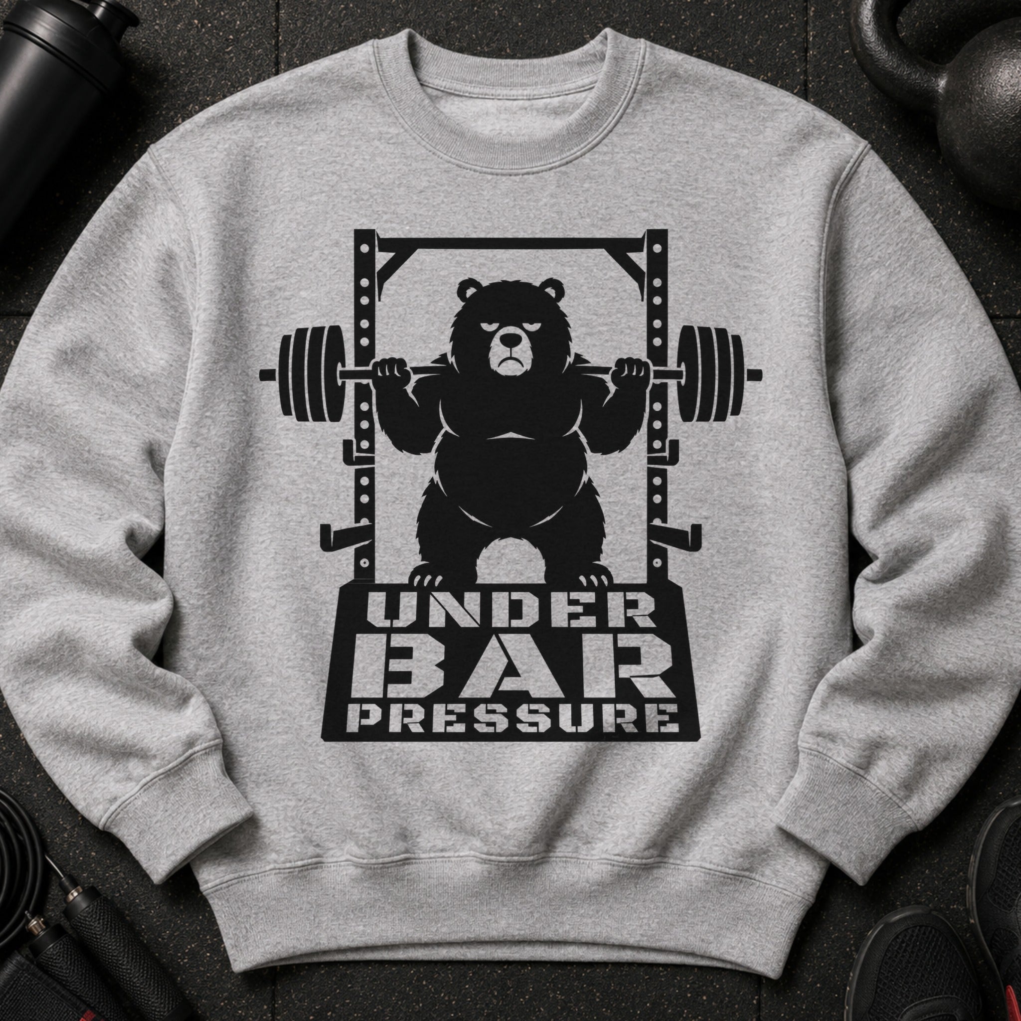 Black graphic of bear on barbell with text "UNDER BAR PRESSURE" on gray sweatshirt.