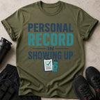 Olive green t-shirt with "PERSONAL RECORD IN SHOWING UP" text and fitness graphics.