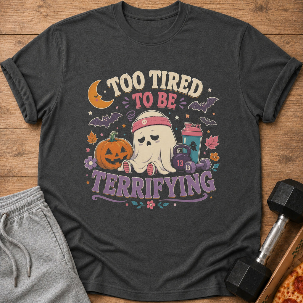 T-shirt with "Too Tired to Be Terrifying" text featuring a tired ghost, pumpkin, and fitness items.