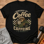 Black t-shirt with graphic "Powered by Coffee Caffeine & Regret" and tired bear holding coffee.