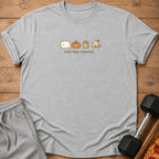 Grey t-shirt with pillow, pumpkin, kettlebell, and coffee graphics and "rest day season" text.