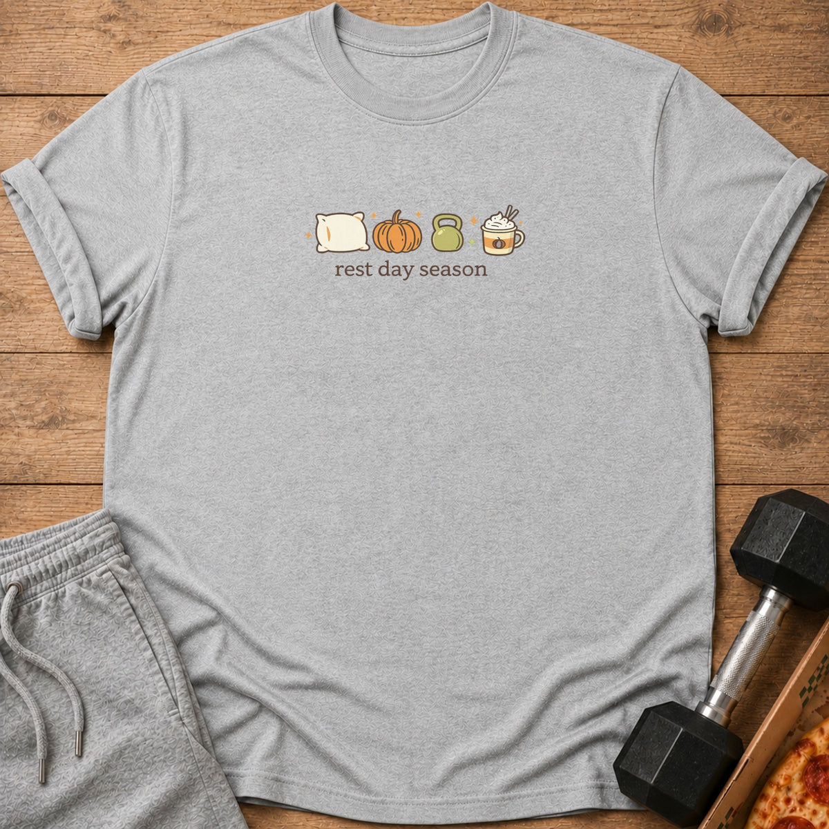 Grey t-shirt with pillow, pumpkin, kettlebell, and coffee graphics and "rest day season" text.