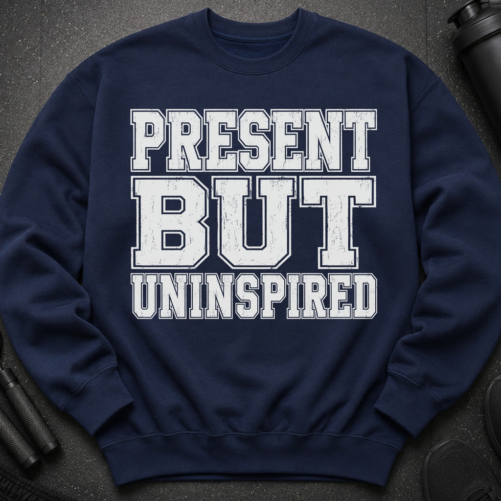 Navy sweatshirt with distressed white text reading "PRESENT BUT UNINSPIRED".