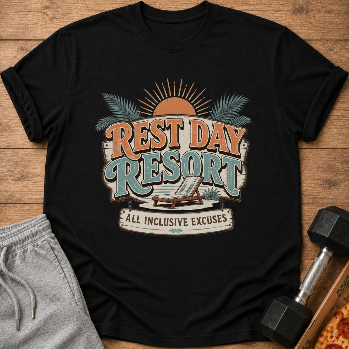 Black t-shirt with "Rest Day Resort All Inclusive Excuses" graphic and beach chair.