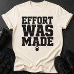 Cream t-shirt with black distressed text "EFFORT WAS MADE" and a kettlebell.