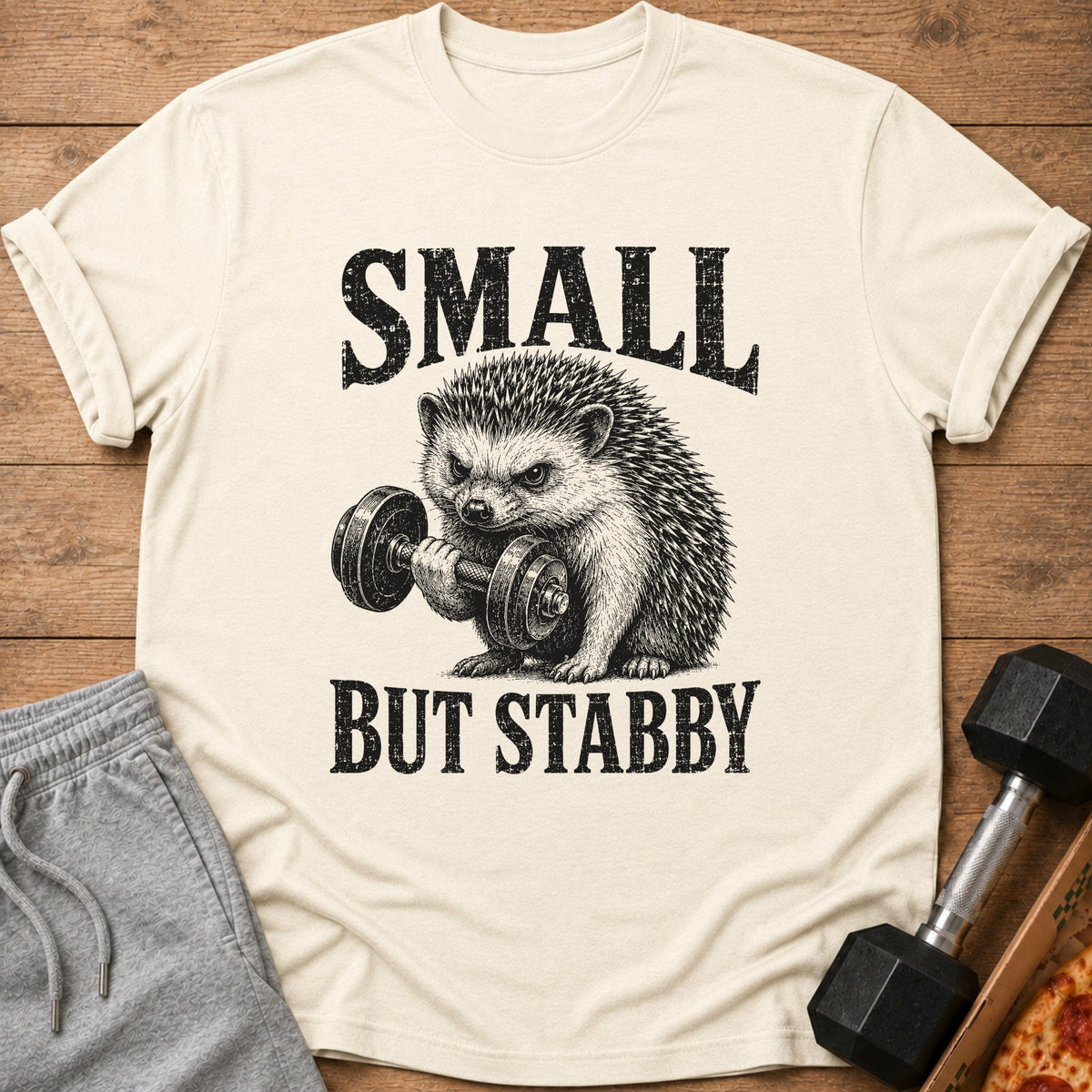 T-shirt with a hedgehog lifting a dumbbell and text "SMALL BUT STABBY".