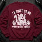 Maroon sweatshirt with skunk drawing and text: "Trained Hard, Complained Harder."