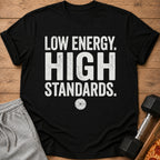 Black t-shirt with distressed white text "LOW ENERGY. HIGH STANDARDS." and a weight plate graphic.