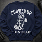 Navy sweatshirt with raccoon graphic and text: SHOWED UP, DONE, REFUSING TO QUIT, THAT'S THE BAR.