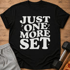 Black t-shirt with white text that reads "JUST ONE MORE SET".
