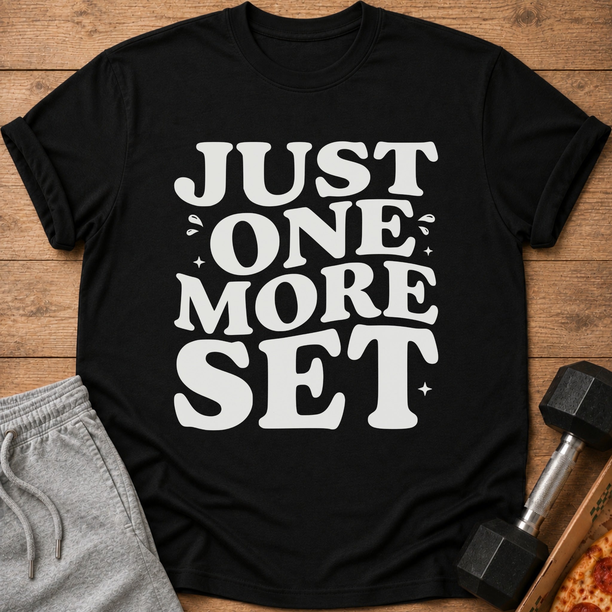 Black t-shirt with white text that reads "JUST ONE MORE SET".