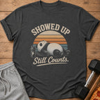 Dark t-shirt with a panda, shaker bottle, and text: Showed Up Still Counts.