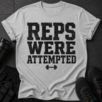 Light grey t-shirt with black text "REPS WERE ATTEMPTED" and a dumbbell.
