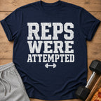 Navy t-shirt with white text "REPS WERE ATTEMPTED" and a dumbbell graphic.