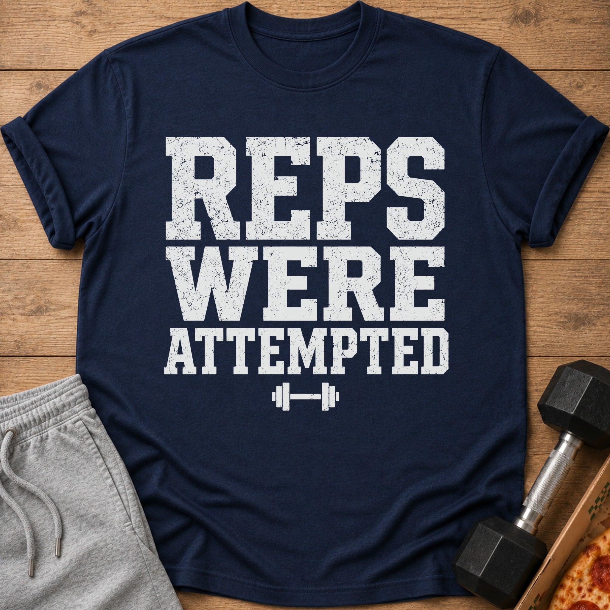Navy t-shirt with white text "REPS WERE ATTEMPTED" and a dumbbell graphic.