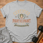 Grey t-shirt with "Certified Participant Club" graphic and kettlebell.