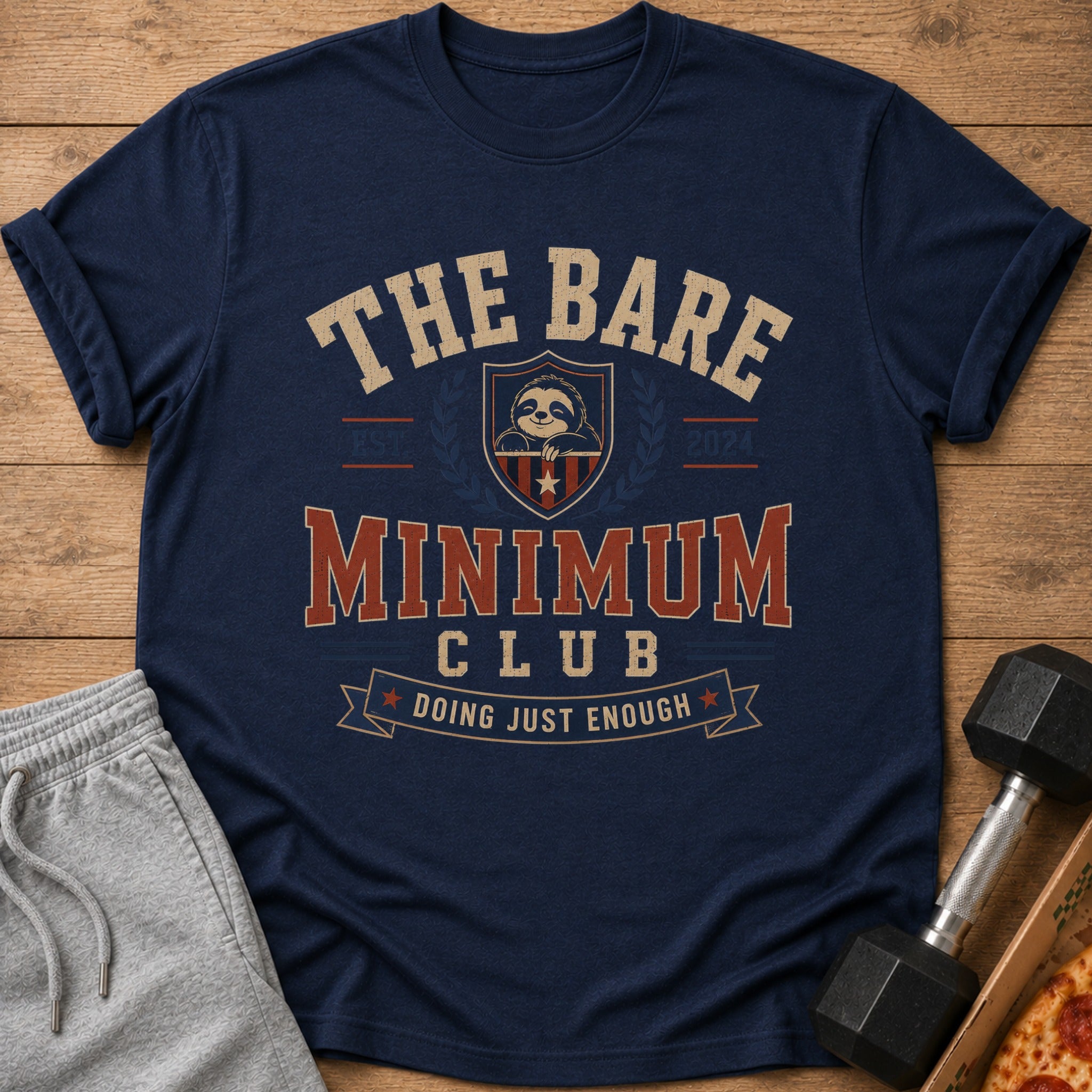 Navy t-shirt with "The Bare Minimum Club" text, a sloth logo, and a banner.