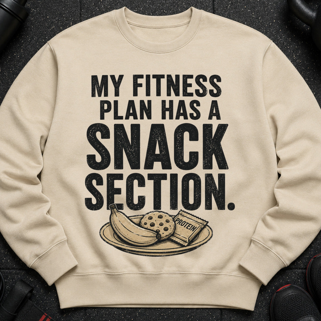 Light beige sweatshirt with "My Fitness Plan Has a Snack Section" text and snacks.